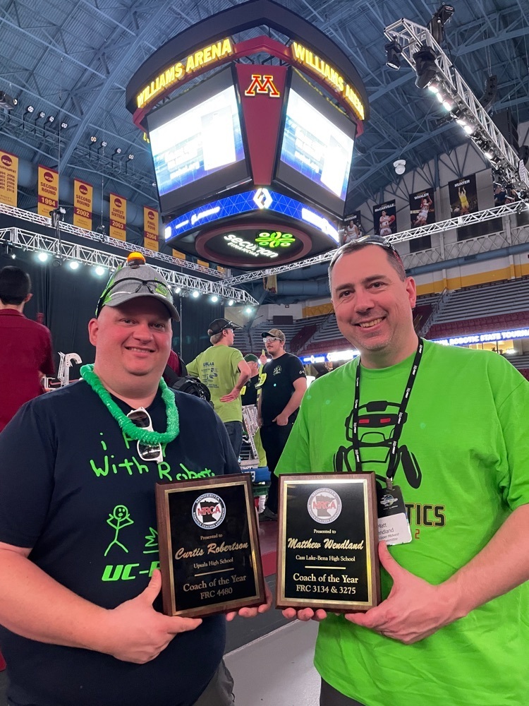 two coaches with awards in arena